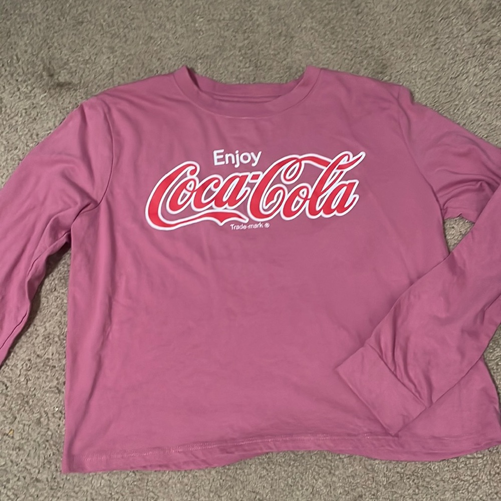 A coca-Cola shirt the size is adult small never been worn